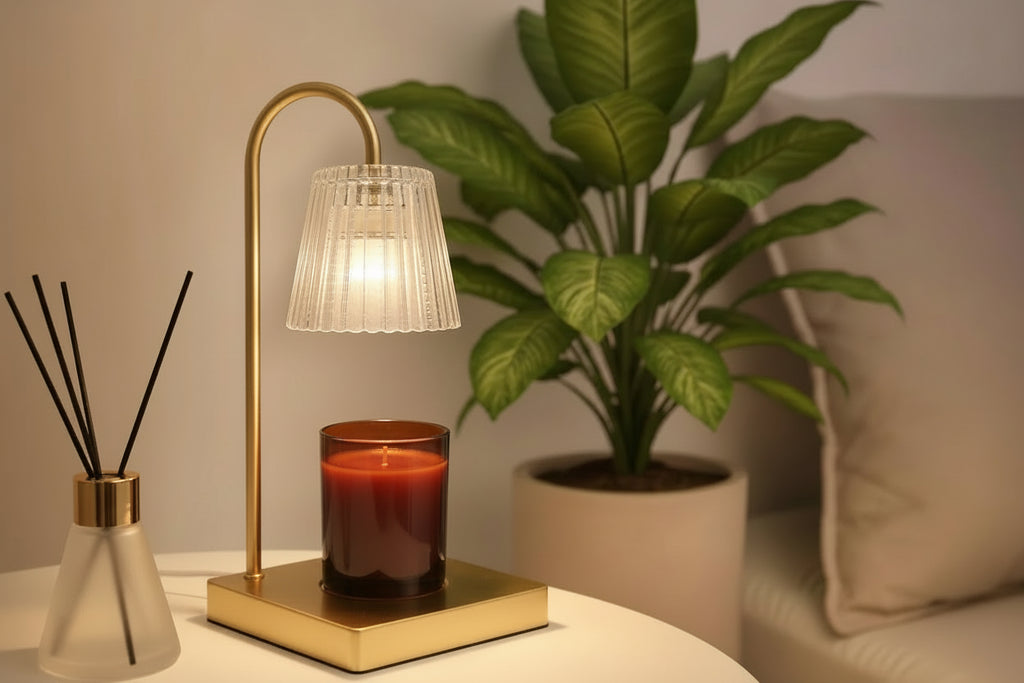 Candle warmer with decorative diffuser on a wooden table with a plant in the background 
